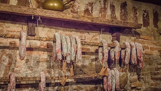 hanging sausages near brown concrete bricks thumbnail