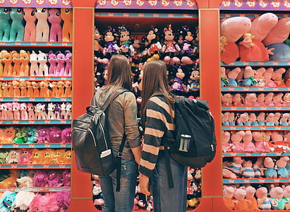 two women standing in front of assorted plush toys thumbnail