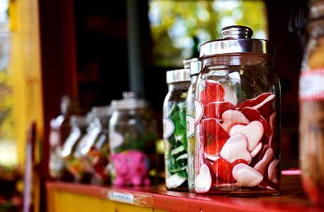 clear glass jars on top of red table surface thumbnail