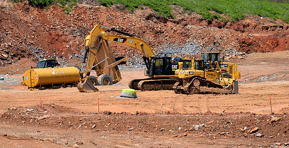 yellow excavator during daytime thumbnail