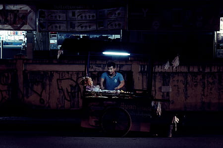 man standing near street cart thumbnail