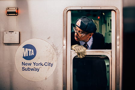 man looking outside train door thumbnail