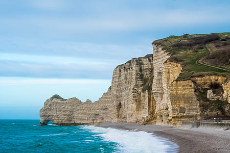 brown rock mountain near seas thumbnail