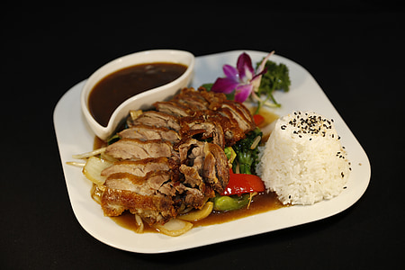 beef steak with rice and sauce on plate thumbnail