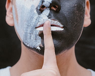 man face with black and white face painting thumbnail