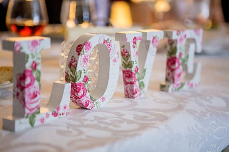 pink and white floral Love freestanding letters on table thumbnail