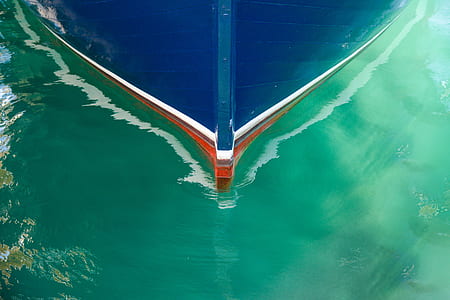 blue wooden boat on body of water thumbnail