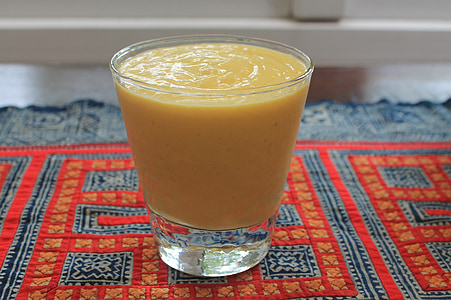 clear glass filled with yellow smoothie thumbnail