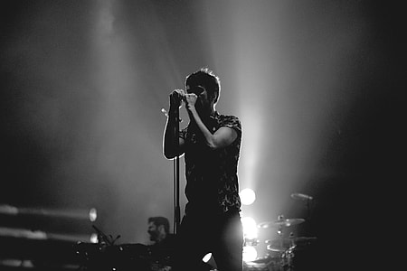 A man signing on stage at a music concert thumbnail