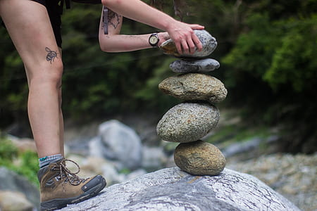 person making balance stone thumbnail
