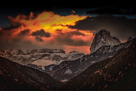 brown and black mountains under red, gray, and brown cloudy sky thumbnail
