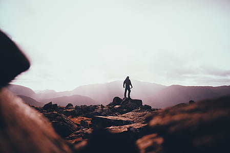 man standing on rock ledge thumbnail