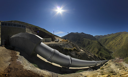 gray metal tube near mountains at daytime thumbnail