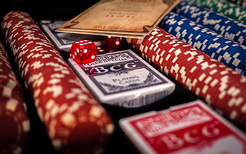 playing cards in middle of assorted poker chips thumbnail