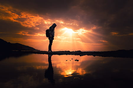 Silhouette Of A Person During Golden Hour thumbnail