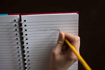 Person Writing on White Lined Paper thumbnail