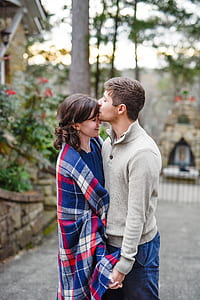 man kissing woman's forehead while holding hands thumbnail