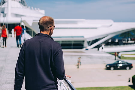 man standing beside handrail outdoor thumbnail