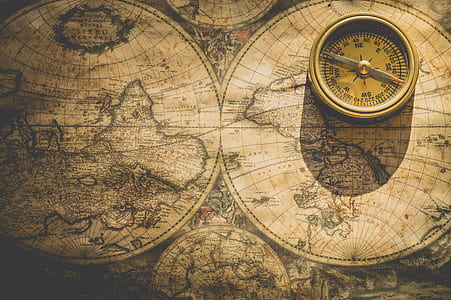 photography of world map and compass thumbnail