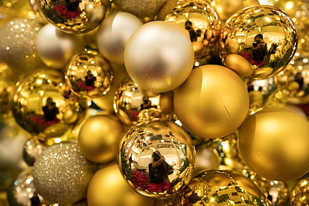 selective focus photography of bunch of gold Christmas baubles thumbnail