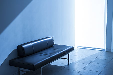 black leather bench near wall inside room thumbnail