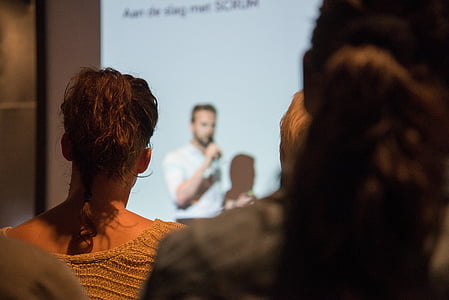 person in white shirt presenting on crowd thumbnail