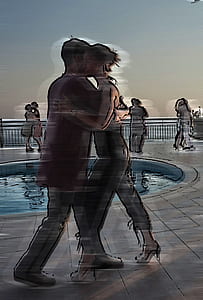 woman and man dancing beside pool thumbnail