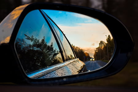 closeup photo of vehicle side mirror reflecting pavement thumbnail