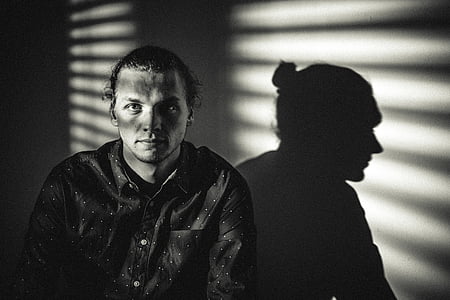 grayscale photo of man near wall thumbnail