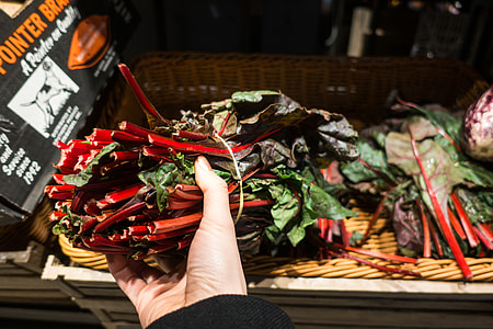 Choosing red swiss chard in a grocery store thumbnail