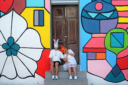 man and woman sitting in front of door thumbnail