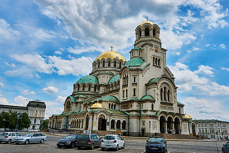 cars parked near concrete church thumbnail