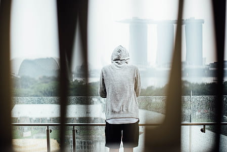 man standing on balcony facing Marina Bay Sands in Singapore thumbnail