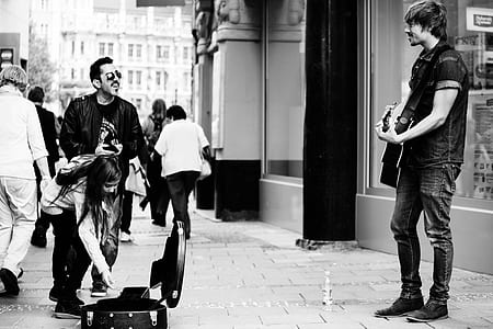 man playing guitar on street thumbnail