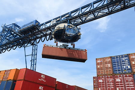 blue crane lifting red shipping container thumbnail