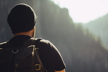 selective focus photo of man wearing black shirt and cap thumbnail
