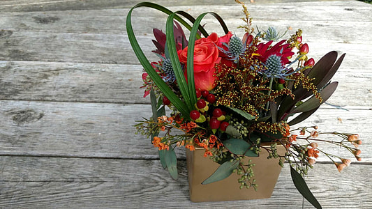 assorted-color flowers on brown planter pot thumbnail