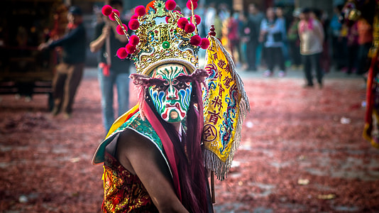 person wearing festival mask thumbnail