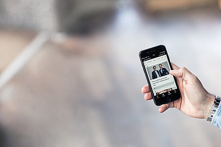 selective focus photo of person holding black iPhone 7 thumbnail
