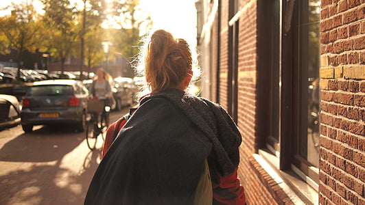 woman walking beside wall thumbnail