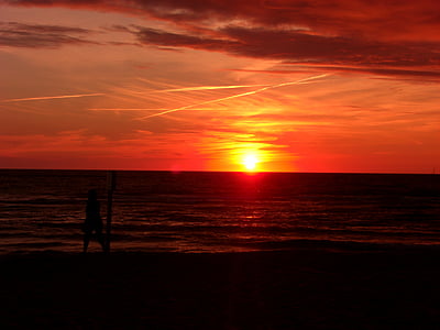 man standing on seashore during sunset thumbnail