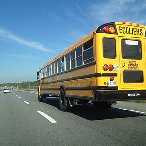 yellow bus on highway thumbnail