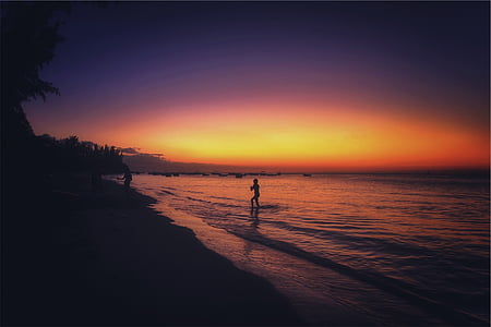 silhouette photo of woman on shore thumbnail