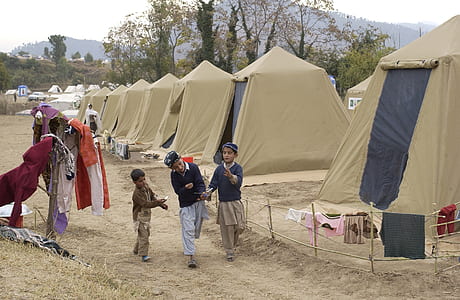 three boy nearby brown tent thumbnail