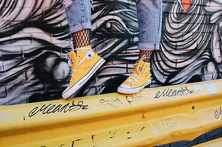 person standing on yellow barricade thumbnail