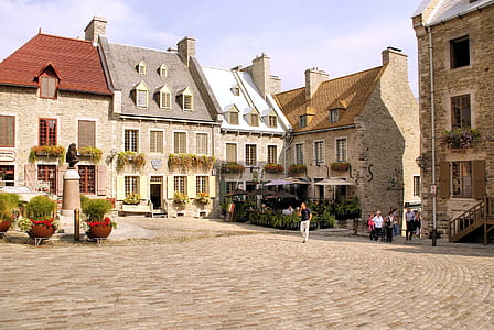 people walking near houses during daytime thumbnail