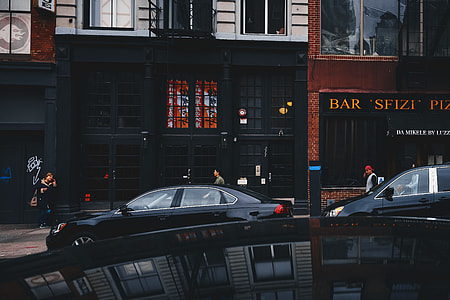 black sedan in front of store facade thumbnail
