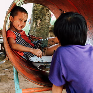 boy sitting on brown tunnel thumbnail