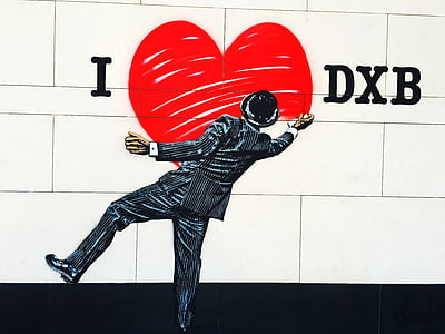 man painting i love DXB on wall painting thumbnail
