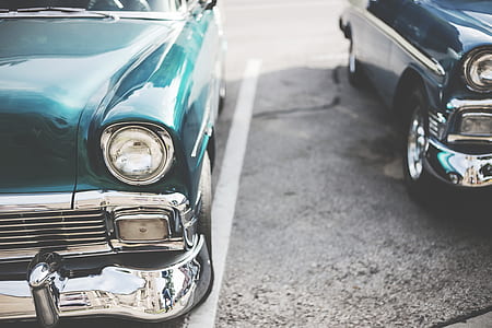 two vintage teal and black cars thumbnail